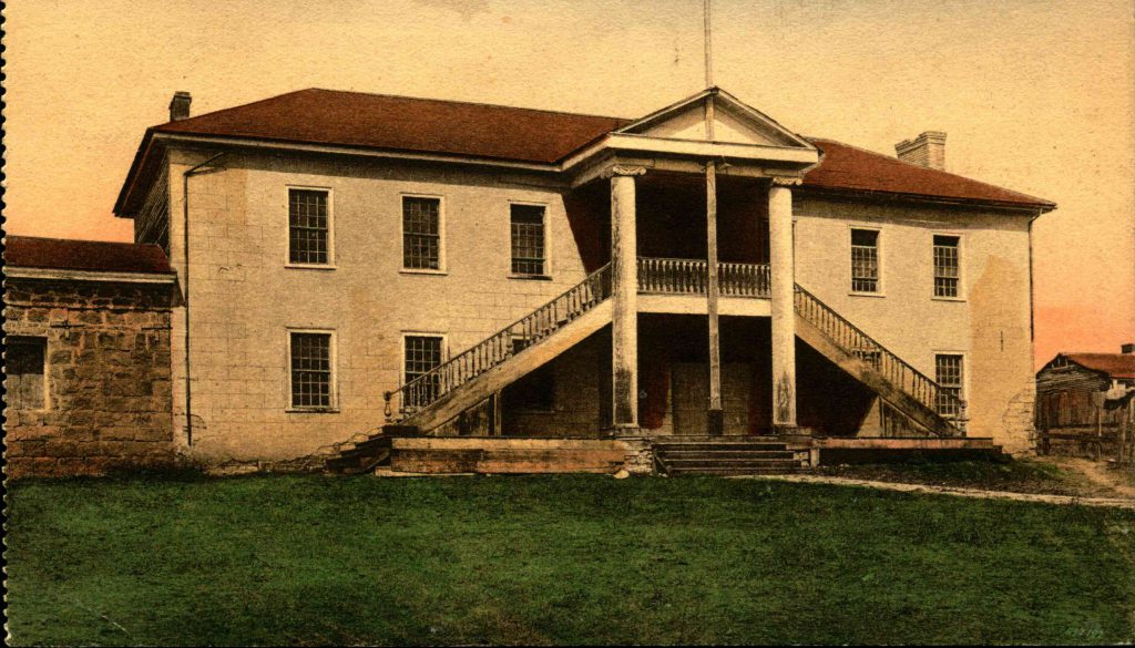 Exterior of Colton Hall with a flagpole and lawn