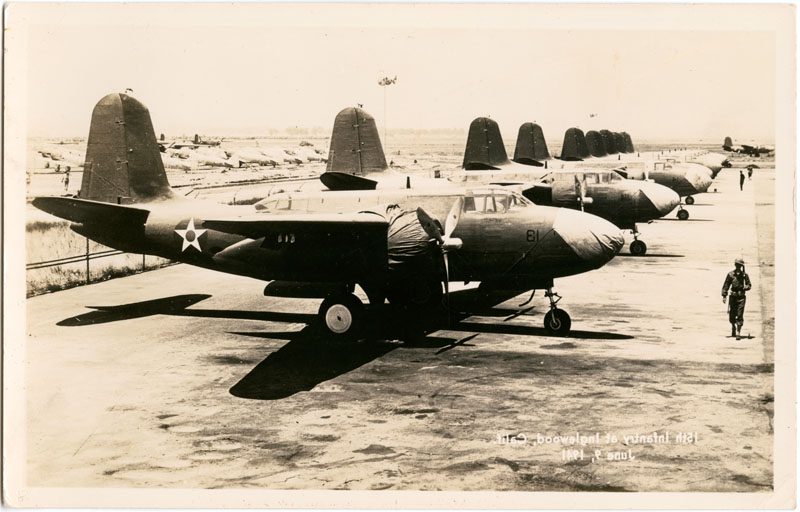 View of soldier marching next to row of airplanes at the North American Aviation plant in Inglewood.