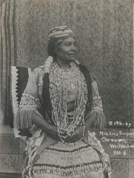 Lucy Thompson in traditional dress with beads and long hair.