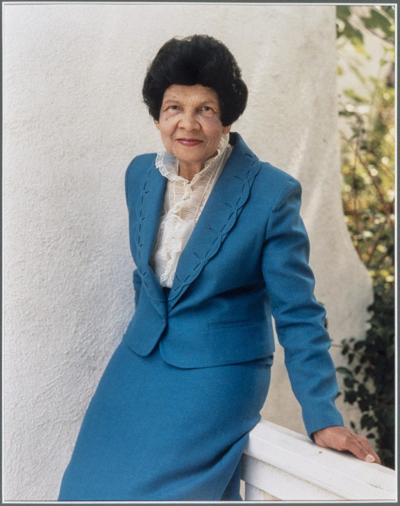 Shows a portrait of Miriam Matthews wearing a blue suit