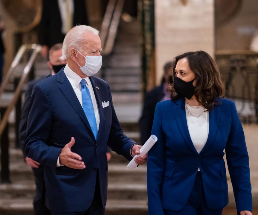 Shows President Biden and Vice President Harris wearing masks while in conversation